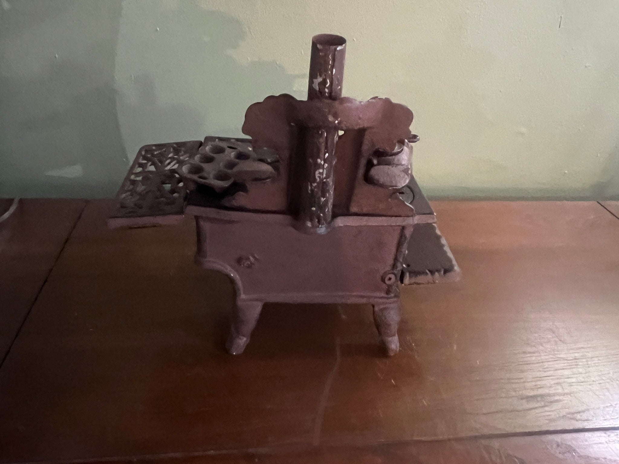 Vintage Crescent cast iron stove with small pots